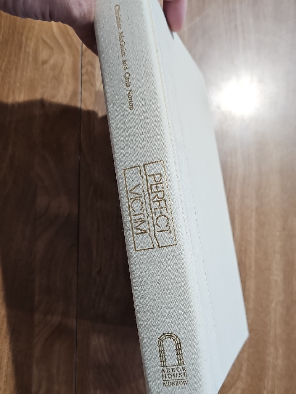 Perfect Victim Hardcover Book in Cream with Gold Lettering